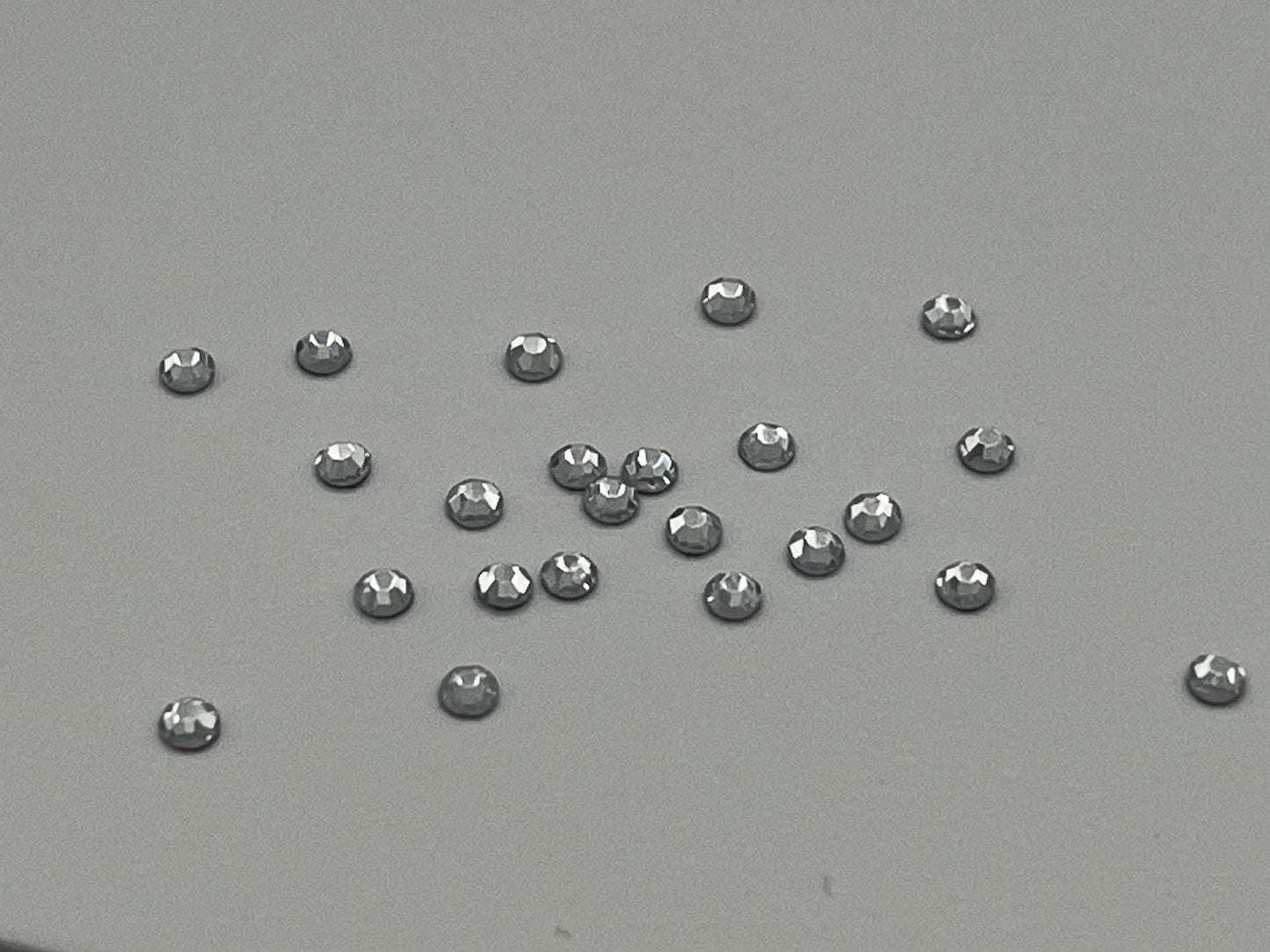 Iron On Hotfix Hot Fix Crystal Rhinestones clear with flat back. 1 pack is 1440 pieces. Price for 1 pack. Size rhinestones SS4 and SS6.