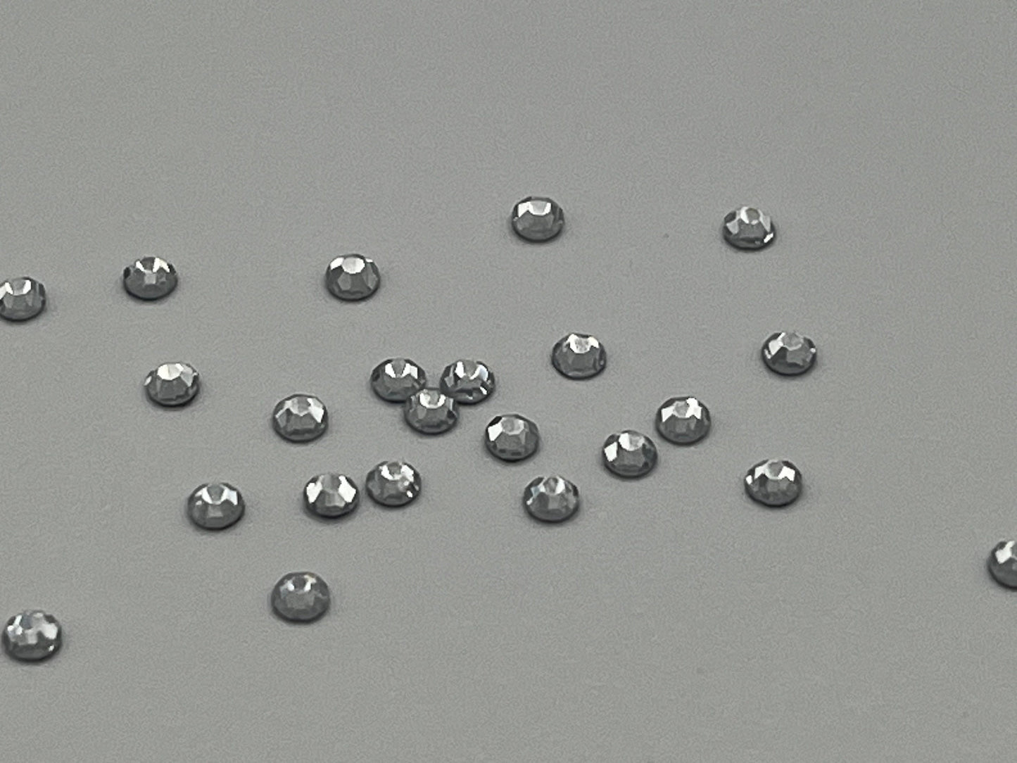 Iron On Hotfix Hot Fix Crystal Rhinestones clear with flat back. 1 pack is 1440 pieces. Price for 1 pack. Size rhinestones SS4 and SS6.