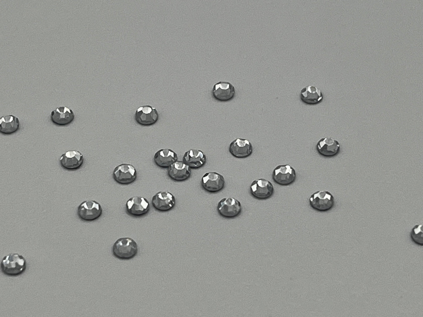 Iron On Hotfix Hot Fix Crystal Rhinestones clear with flat back. 1 pack is 1440 pieces. Price for 1 pack. Size rhinestones SS4 and SS6.