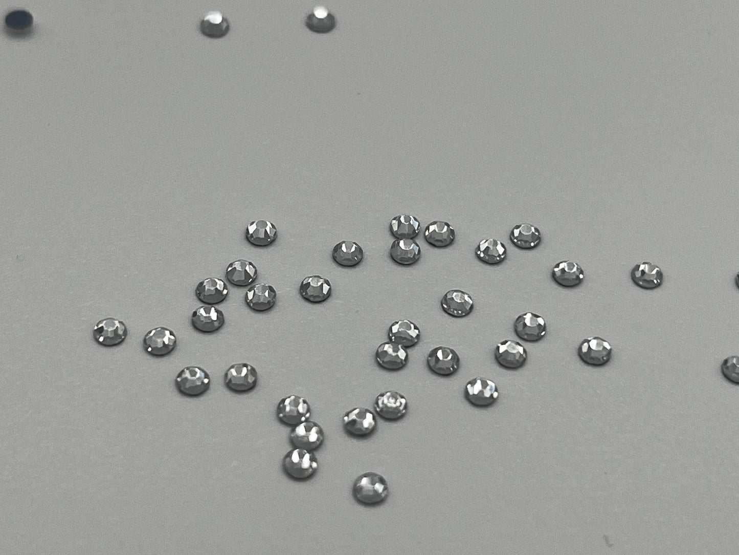 Iron On Hotfix Hot Fix Crystal Rhinestones clear with flat back. 1 pack is 1440 pieces. Price for 1 pack. Size rhinestones SS4 and SS6.