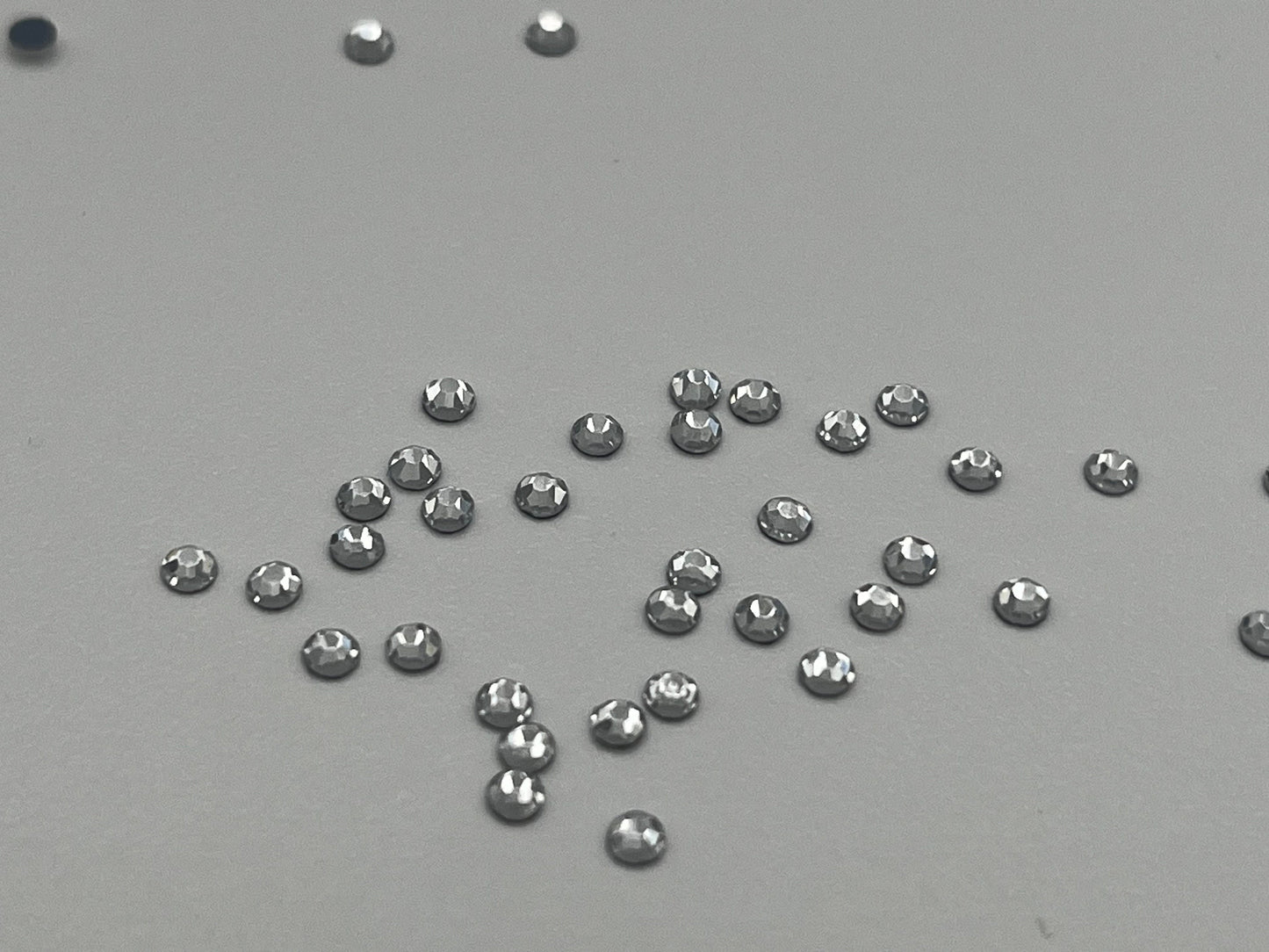 Iron On Hotfix Hot Fix Crystal Rhinestones clear with flat back. 1 pack is 1440 pieces. Price for 1 pack. Size rhinestones SS4 and SS6.